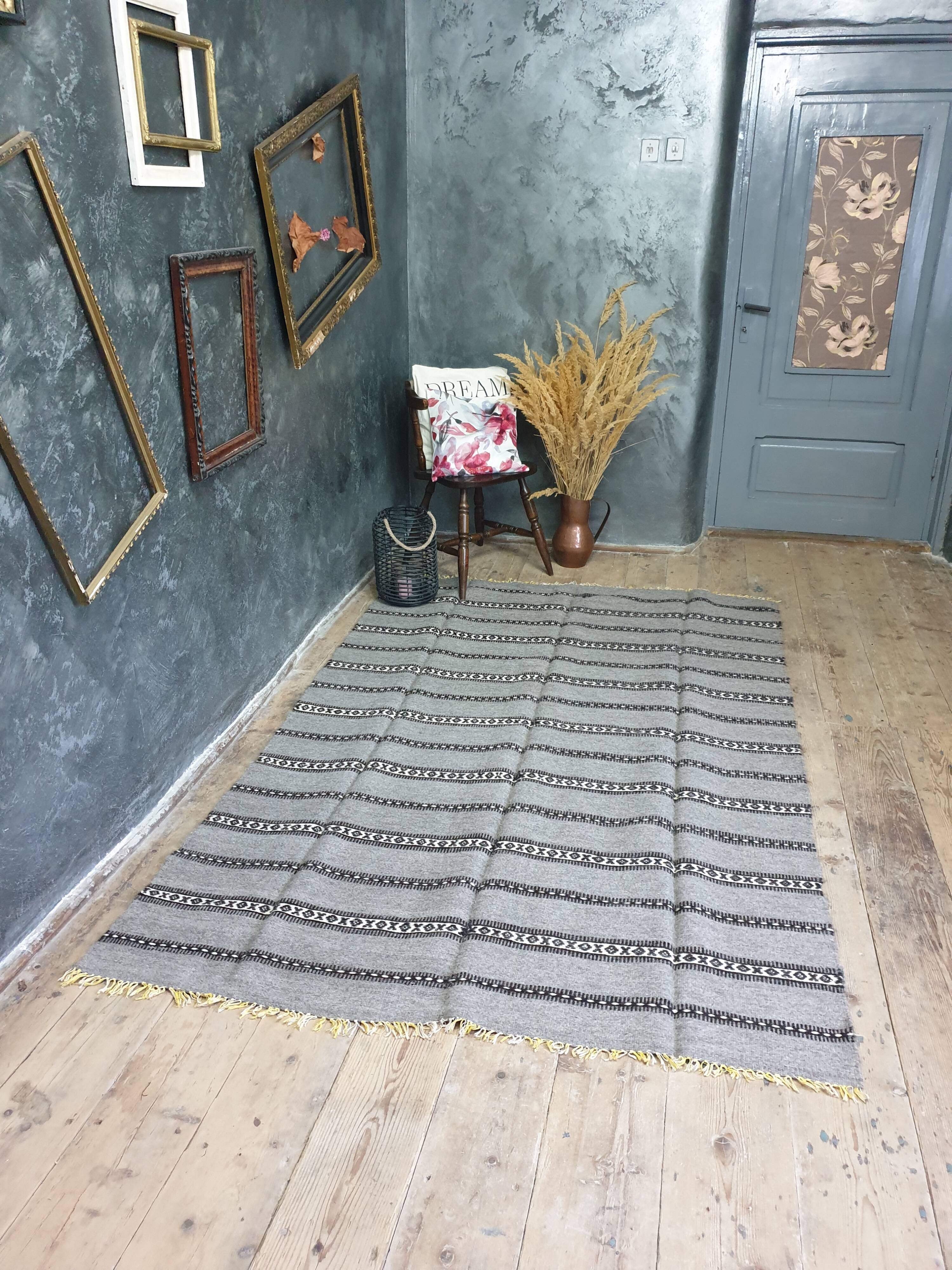 Handwoven vintage geometrical rug, grey background