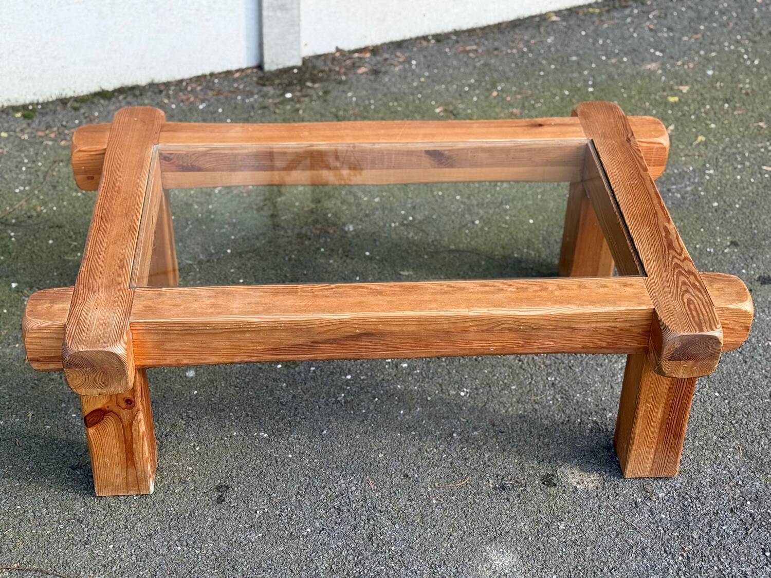 Coffee table with a glass top in Scandinavian brutalist style made of pine.