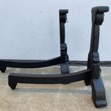 Pair of cast iron chenets with stylized faces High Epoch SEVENTEENTH century