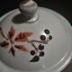 Enamelled sheet metal pourer decorated with black berries early twentieth century