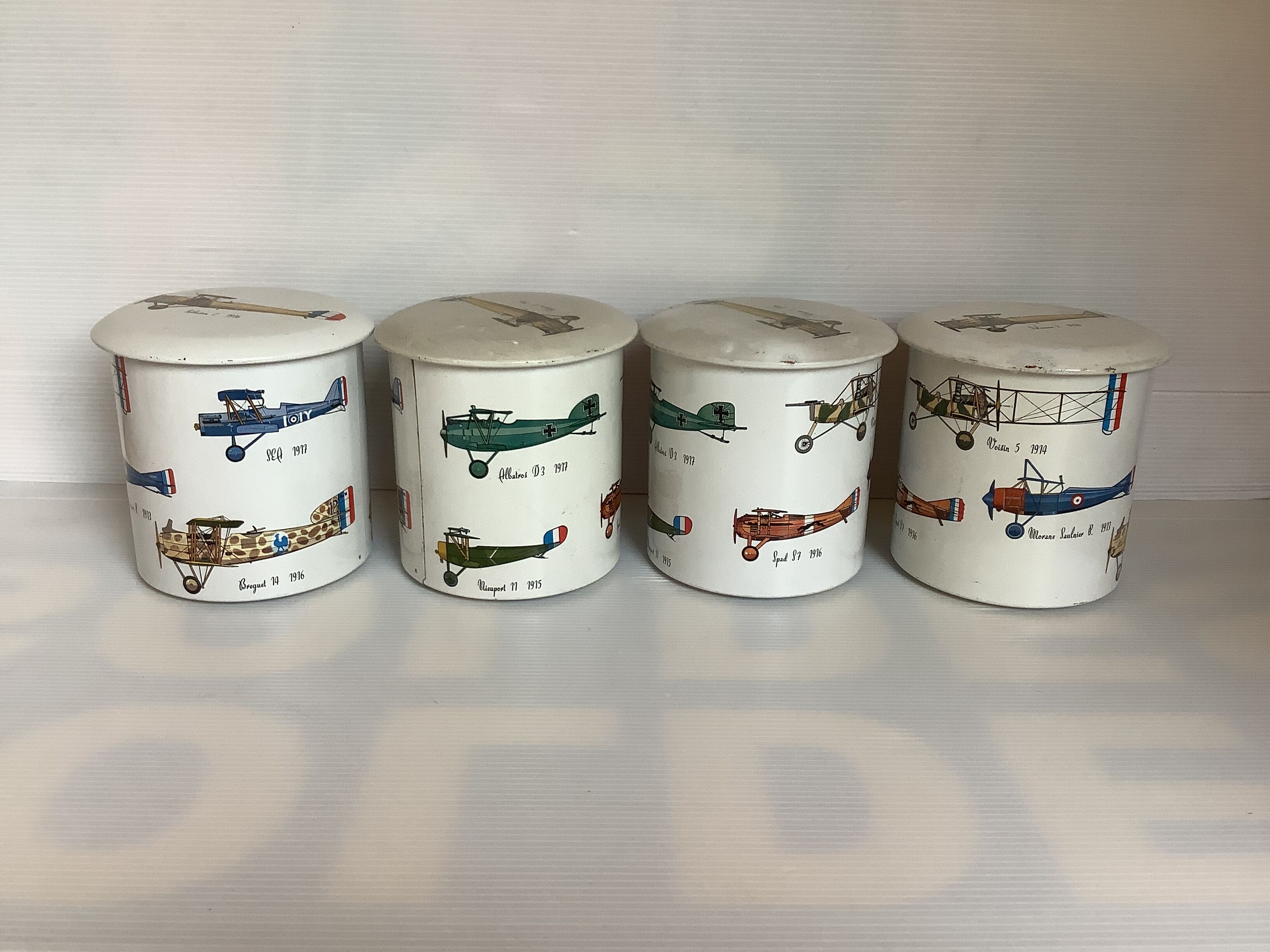 4 old metal boxes lithographed aircraft pattern