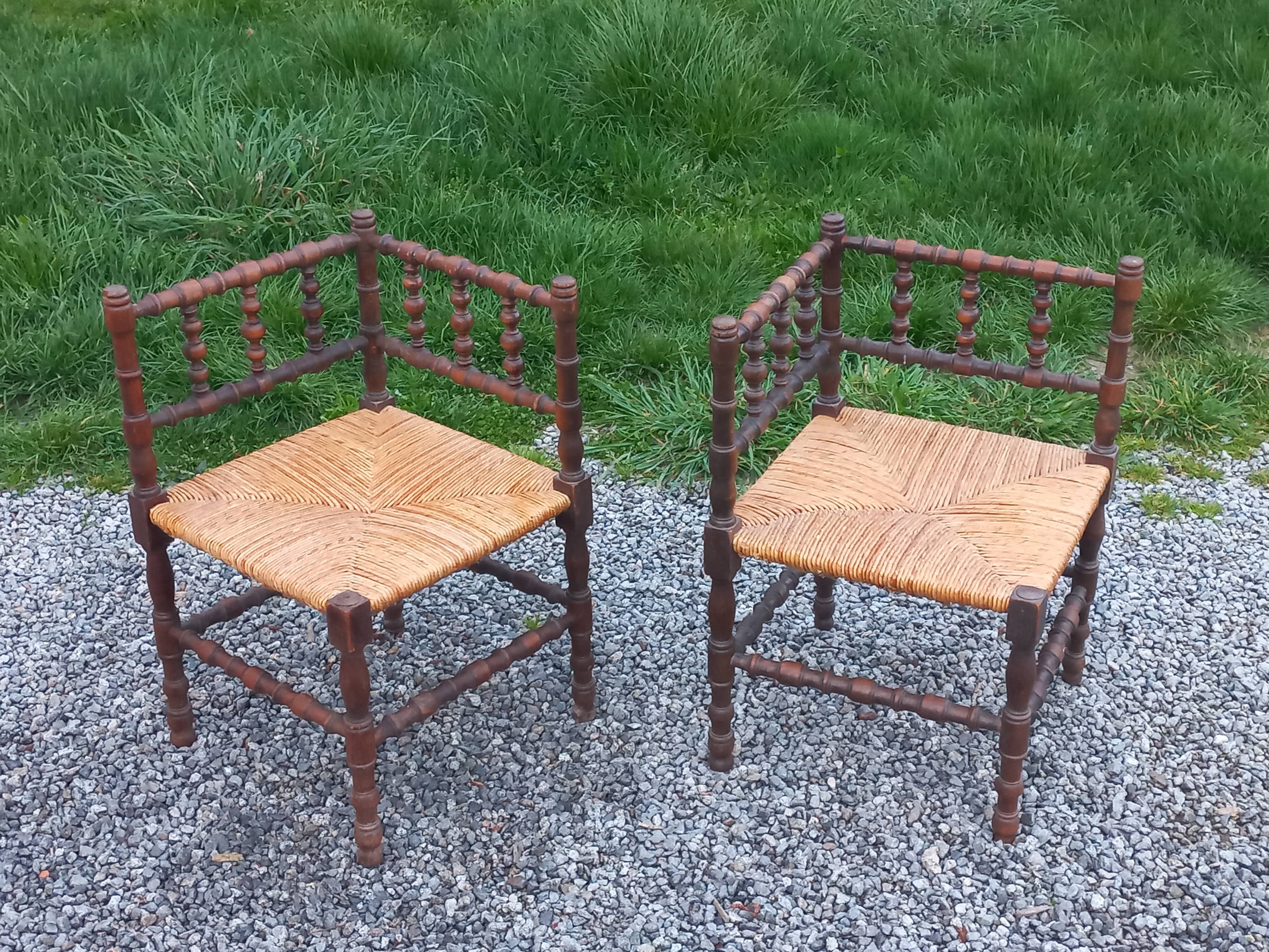 Pair of angled armchairs with turned wood and rush seats from the 1960s.