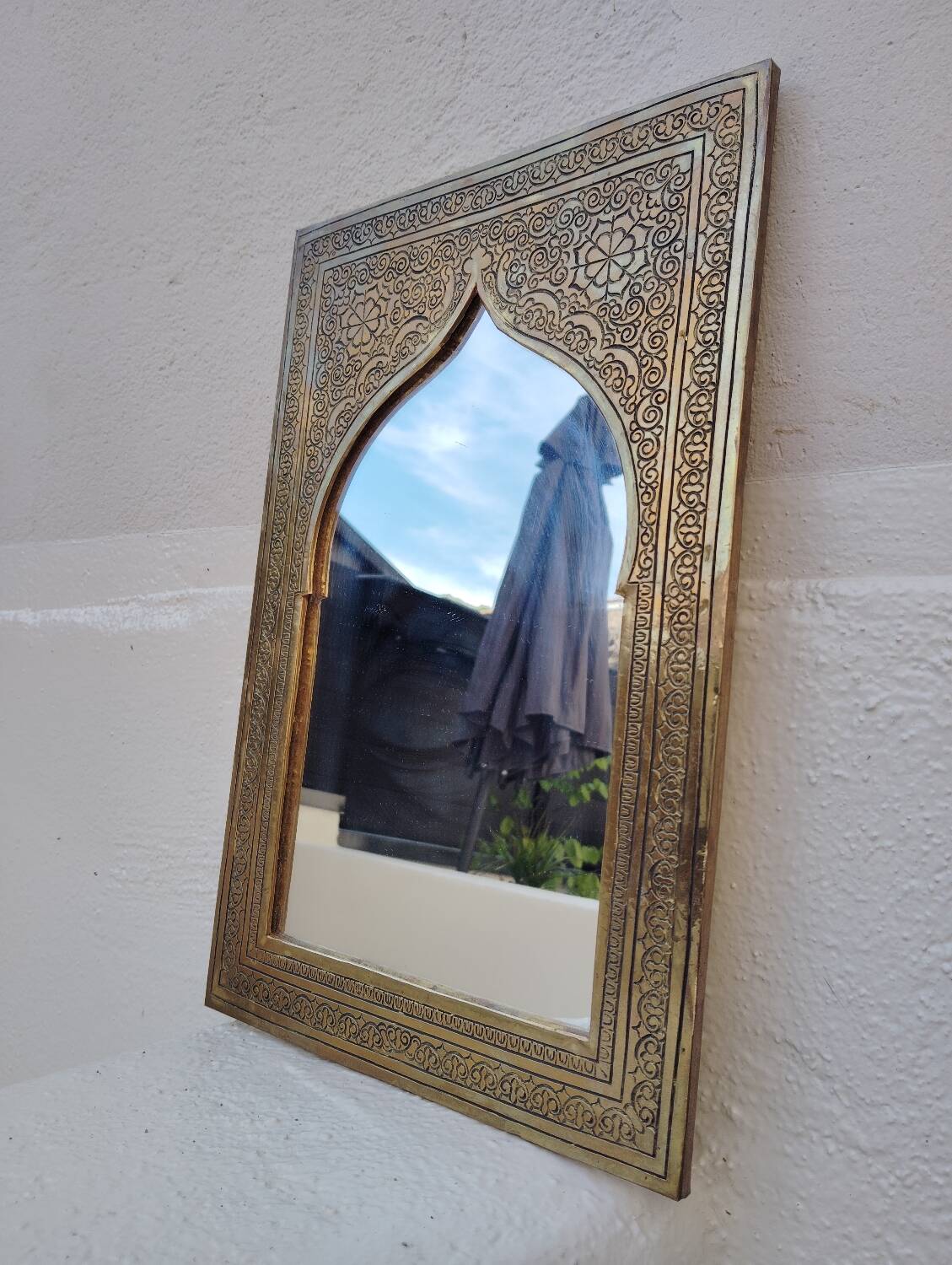 Golden oriental mirror