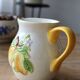 Vintage earthenware and slip pitcher with lemon motif