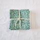 6 green cotton cloth napkins with white linens