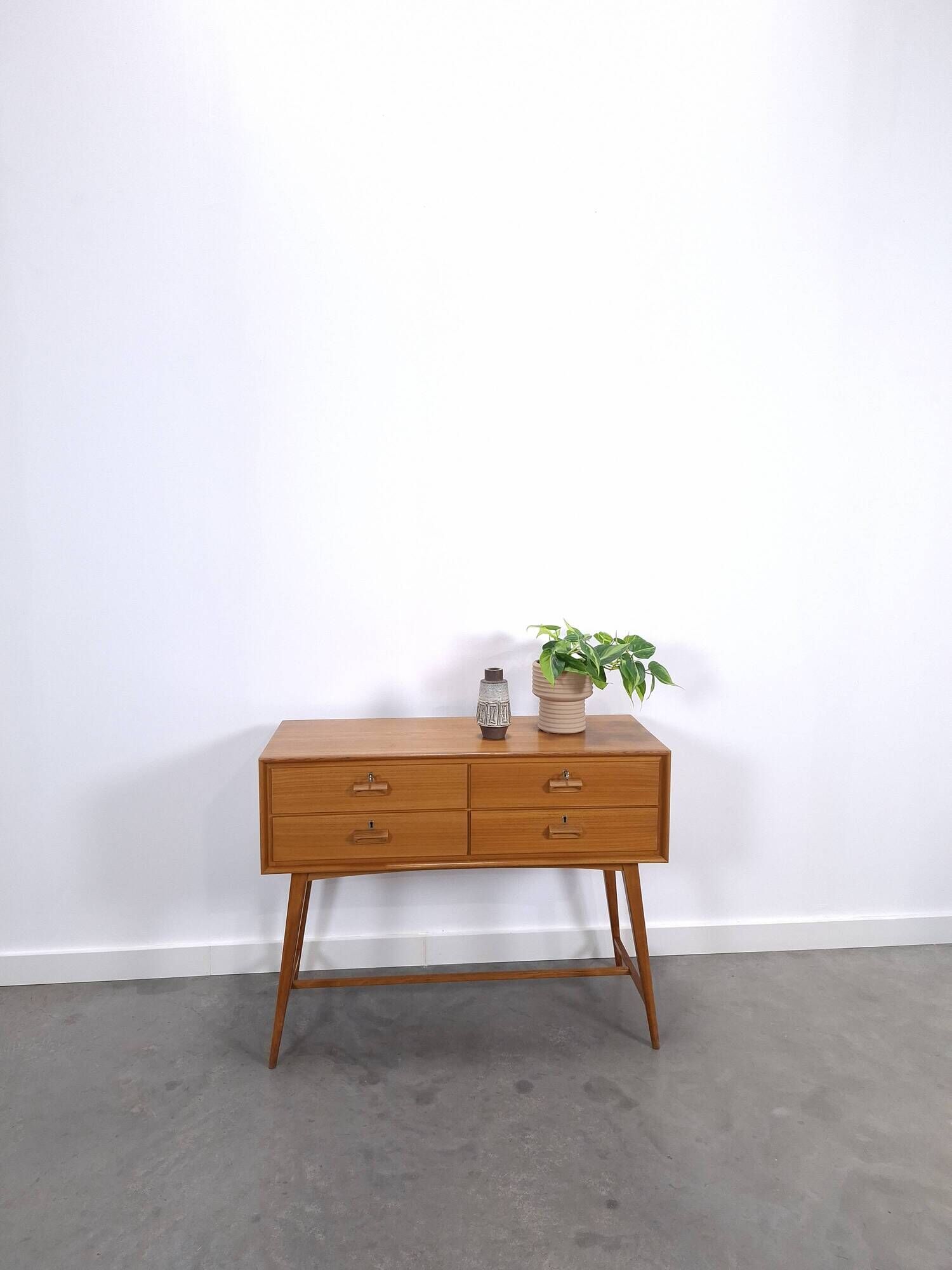 Vintage teak Danish chest of drawers with high slanted legs, side table, sideboard.
