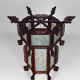 Asian wooden lantern carved with dragons and painted glass panels