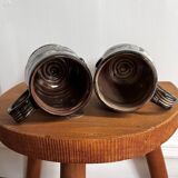 Vintage terracotta mugs with glazed designs and flower/fish motifs