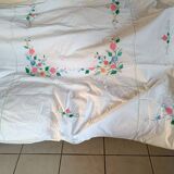 Large white map with colored flower insertion and embroidery.