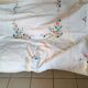 Large white map with colored flower insertion and embroidery.