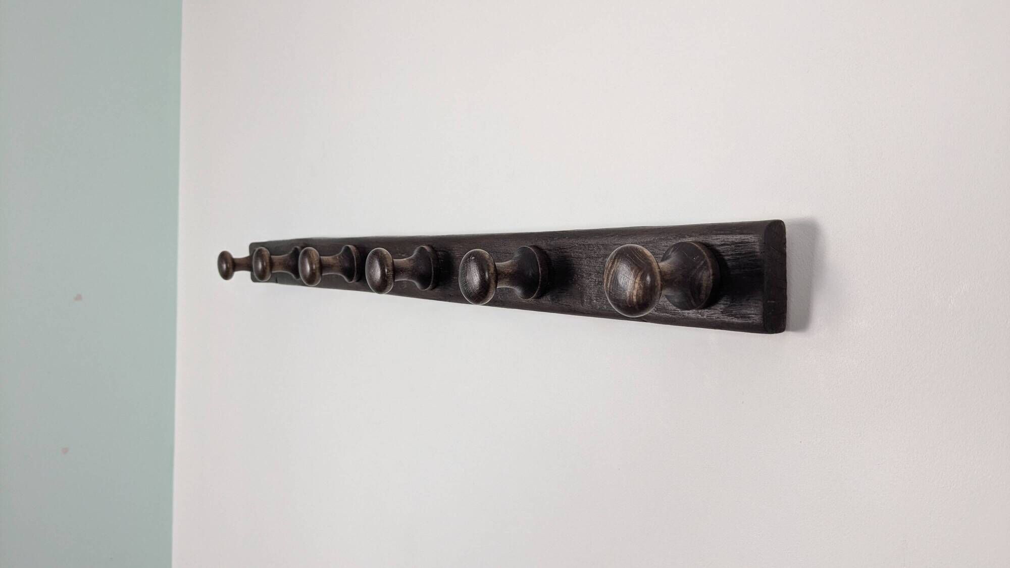 Antique turned wooden coat rack with 6 hooks, rustic spirit.