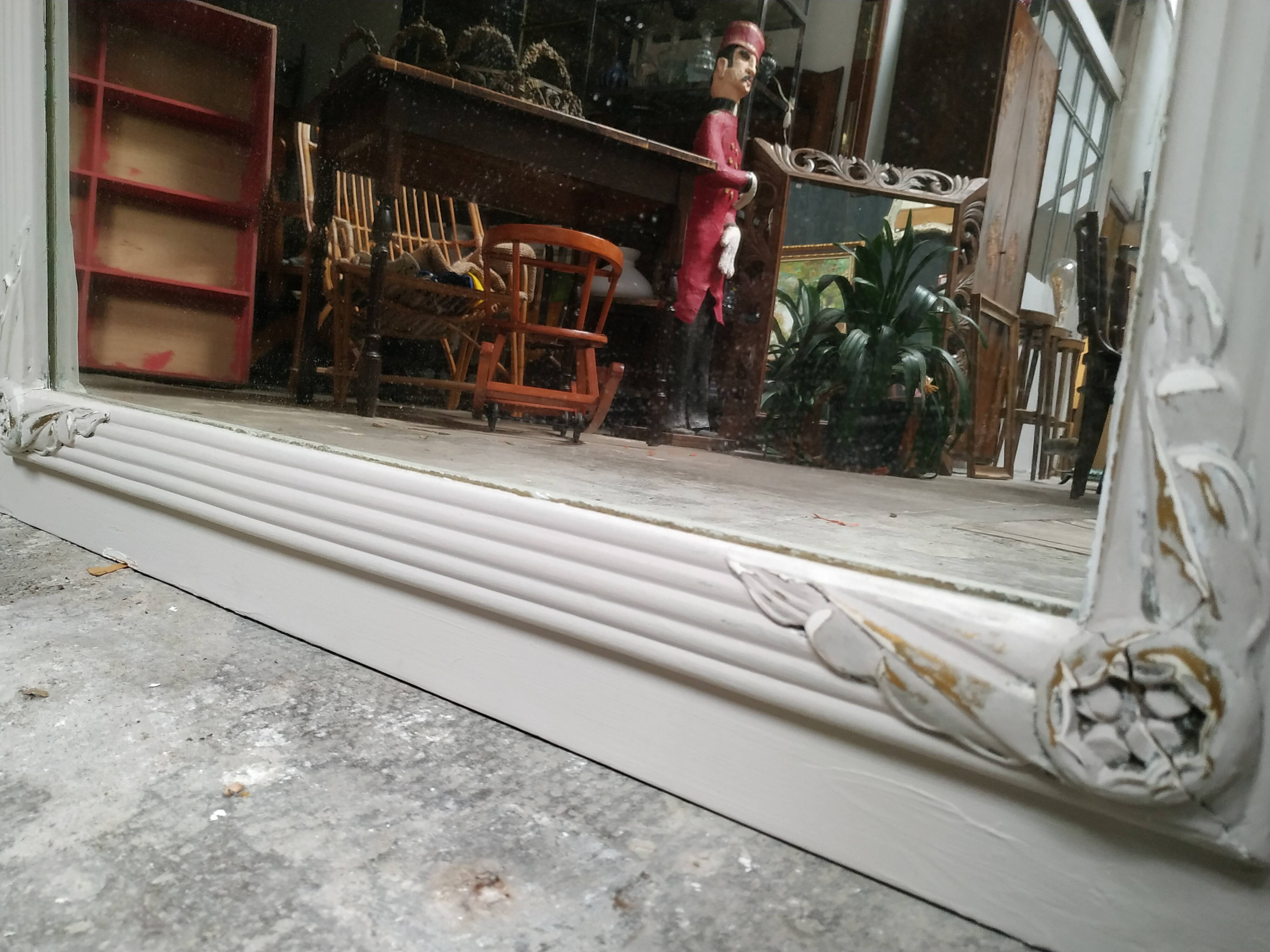 White and gold patinated sculpted mirror