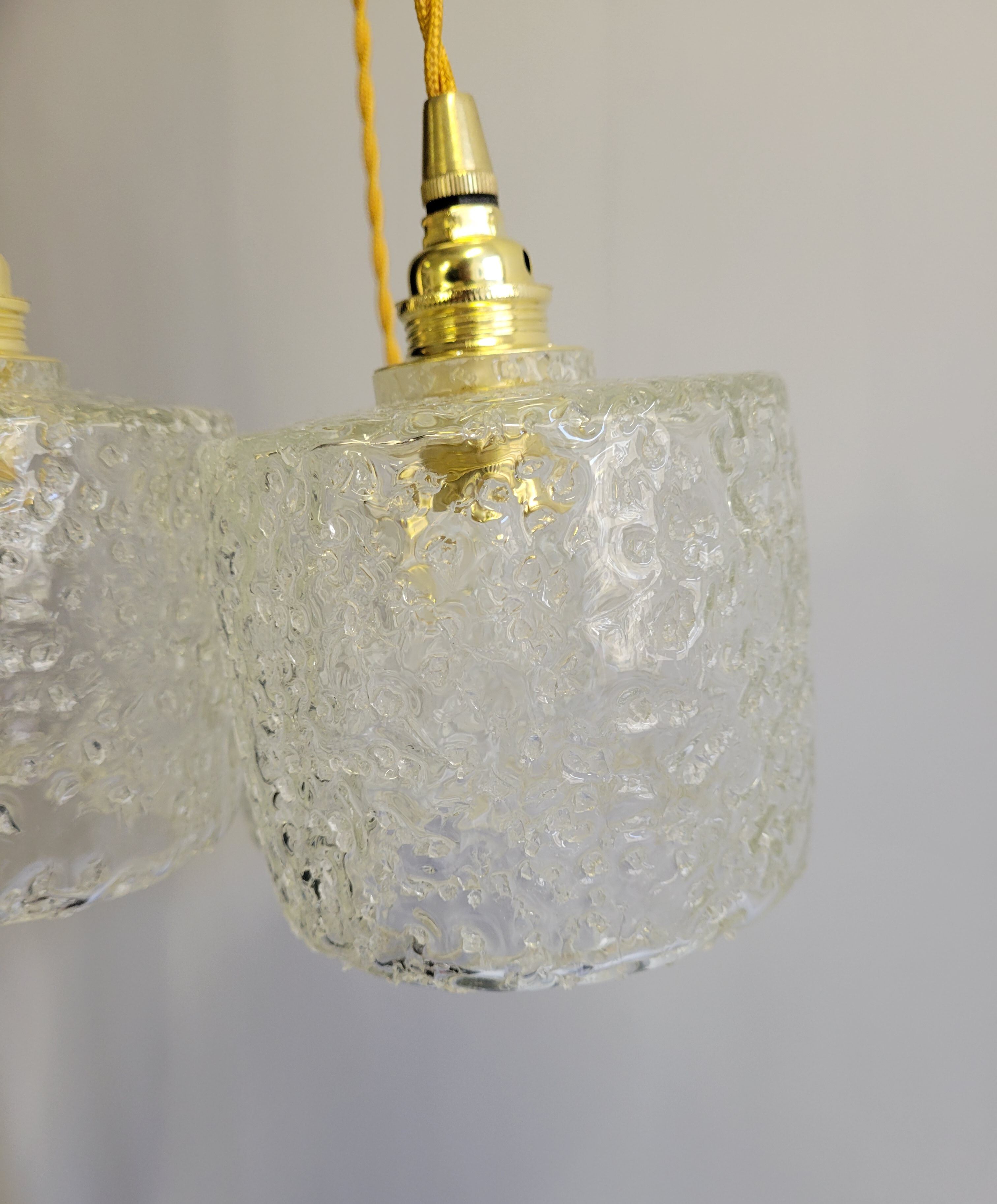 Trio of scrambled glass pendant lamps