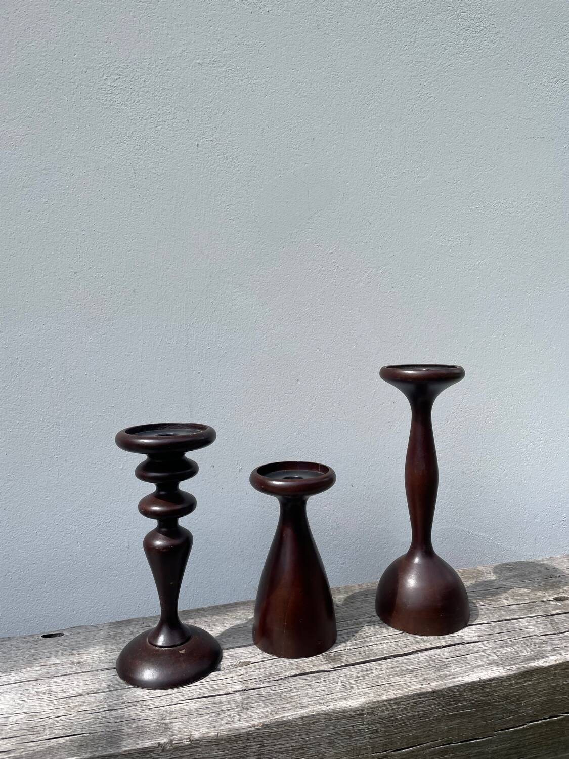 Trio of large turned wooden candlesticks