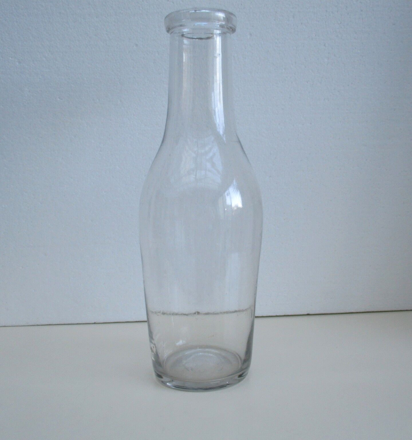 Large antique bottle made of blown glass