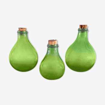 3 green glass bottles