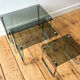 Nest of coffee tables in chrome with smoked glass top.