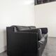 Black leather convertible sofa with goose feather upholstery.