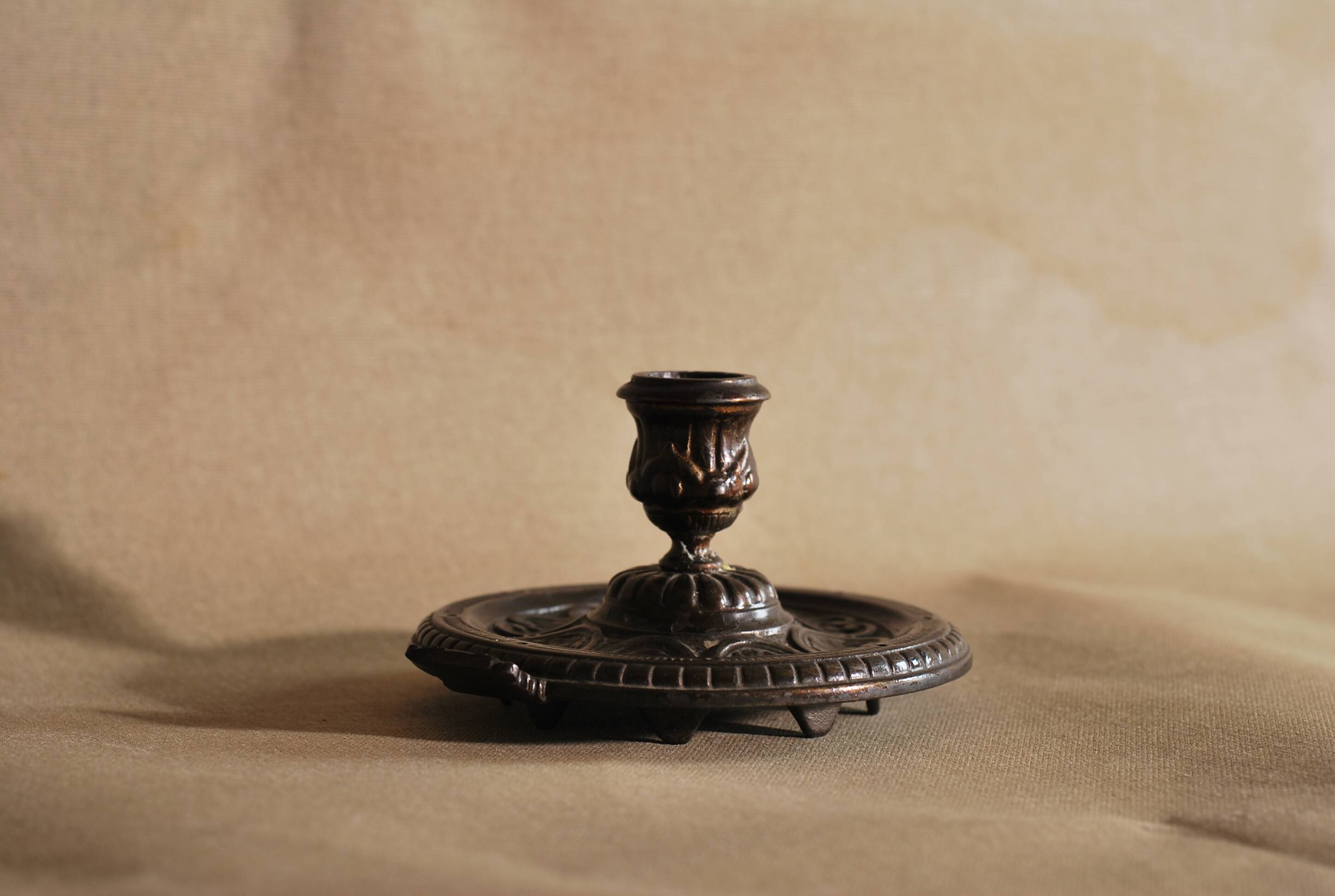 Bronze cellar rat hand candle holder