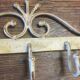 White wrought iron coat and hat rack