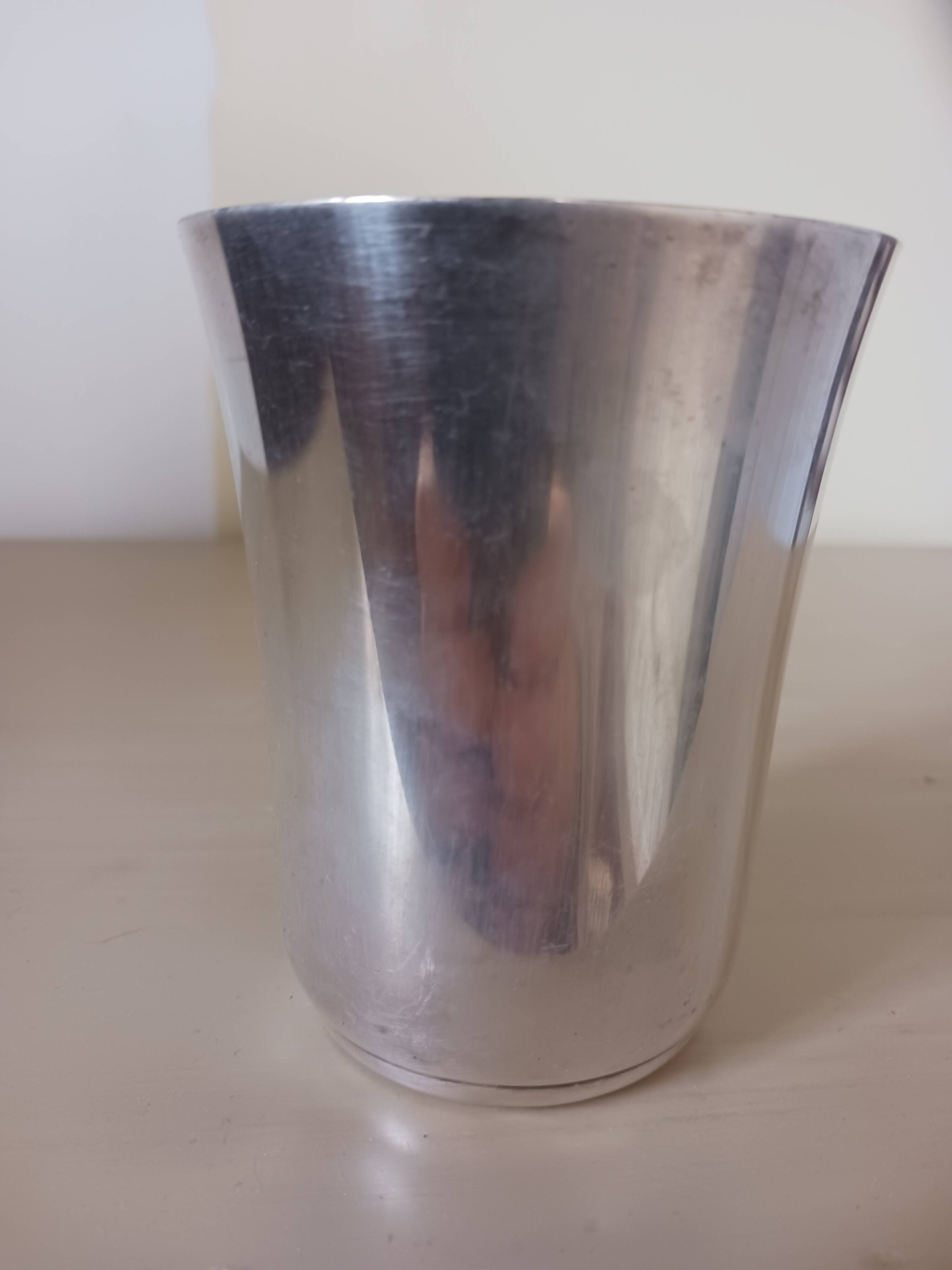 Silver-plated metal tumbler.