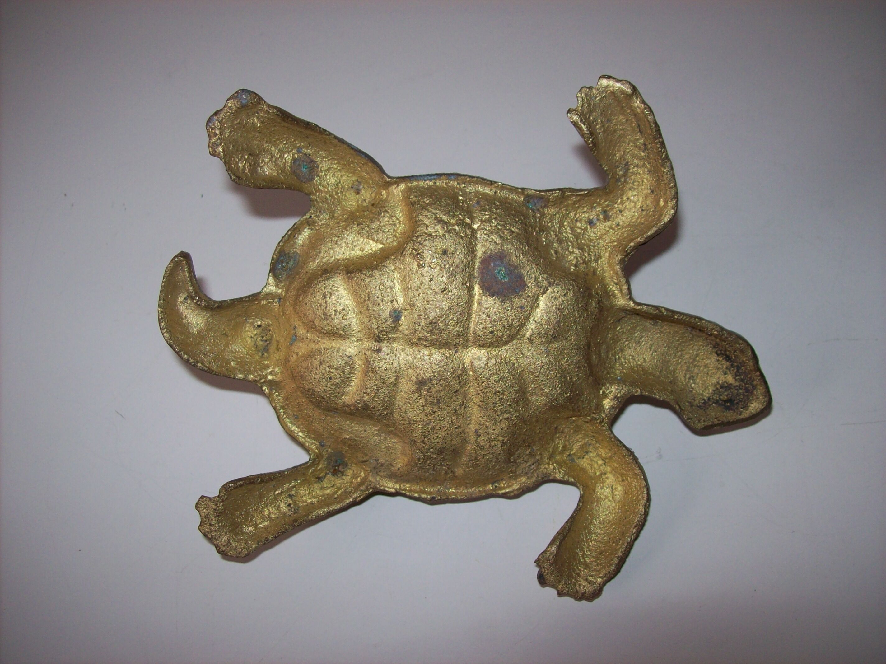 Golden brass ashtray has a turtle-shaped