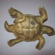 Golden brass ashtray has a turtle-shaped