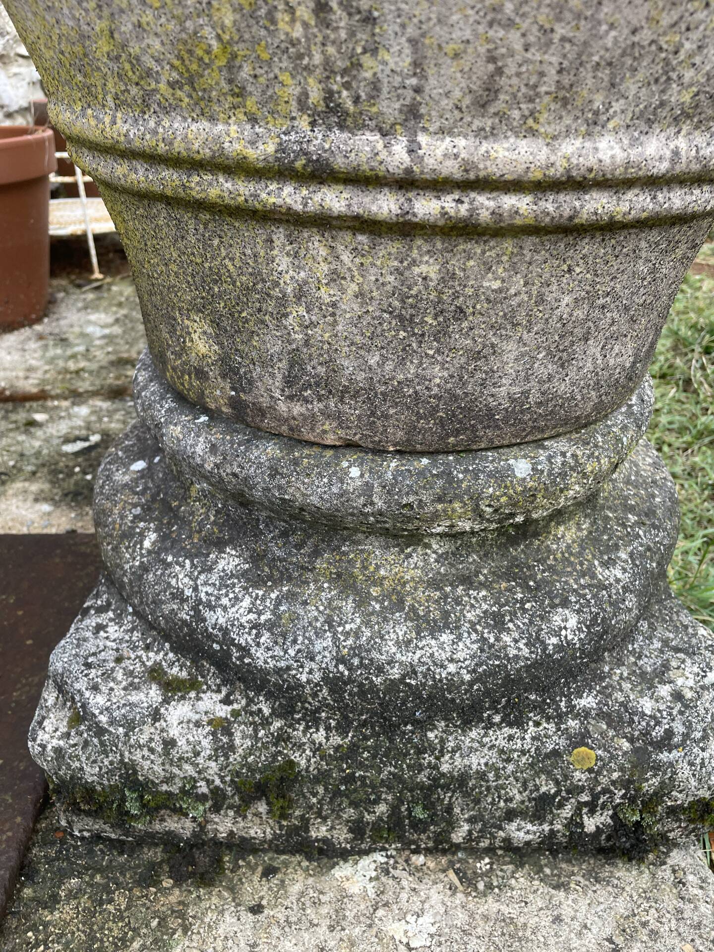 Large Cretan jar in terracotta with three handles on a stone base.