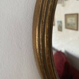 Classic oval mirror in gilded wood.