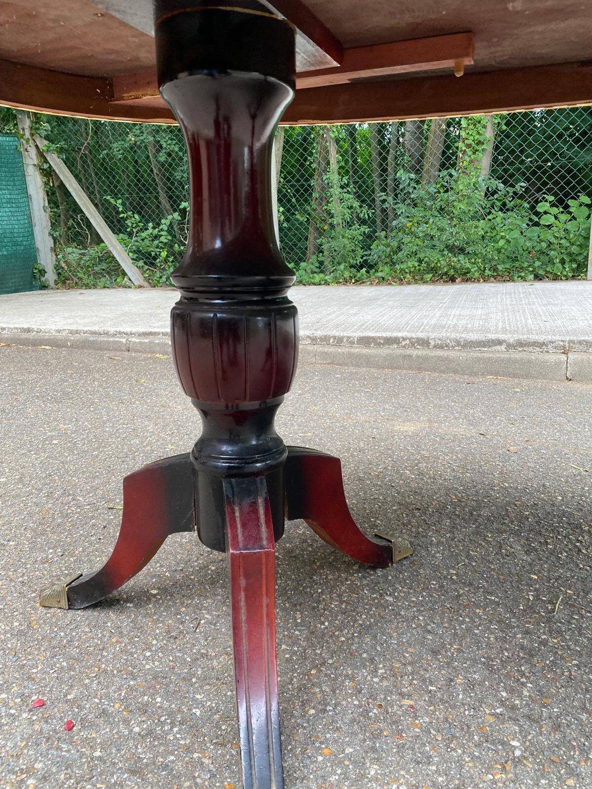 Glossy mahogany dining table in English Regency style from the 1970s.