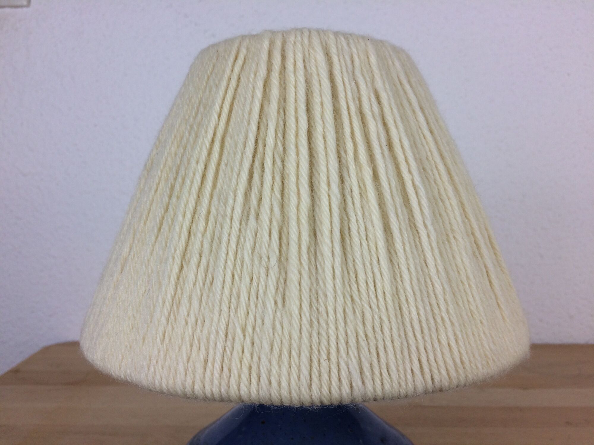 Blue ceramic lamp foot and white wool lampshade