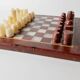 Vintage marble chess set from the 1960s, cream, burgundy and gold board with metal inlay, stone pieces.