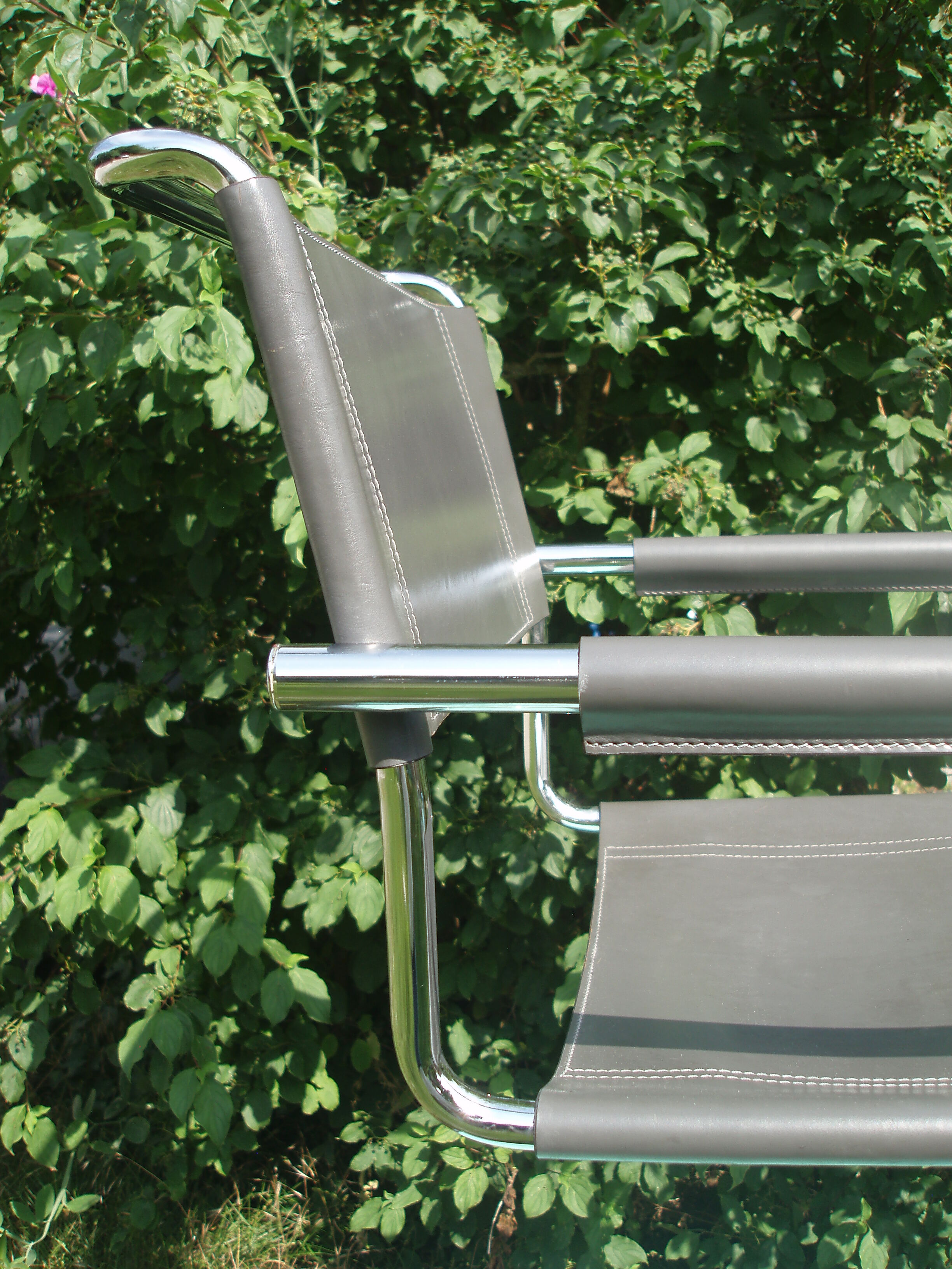 Series of grey and chrome leather armchairs