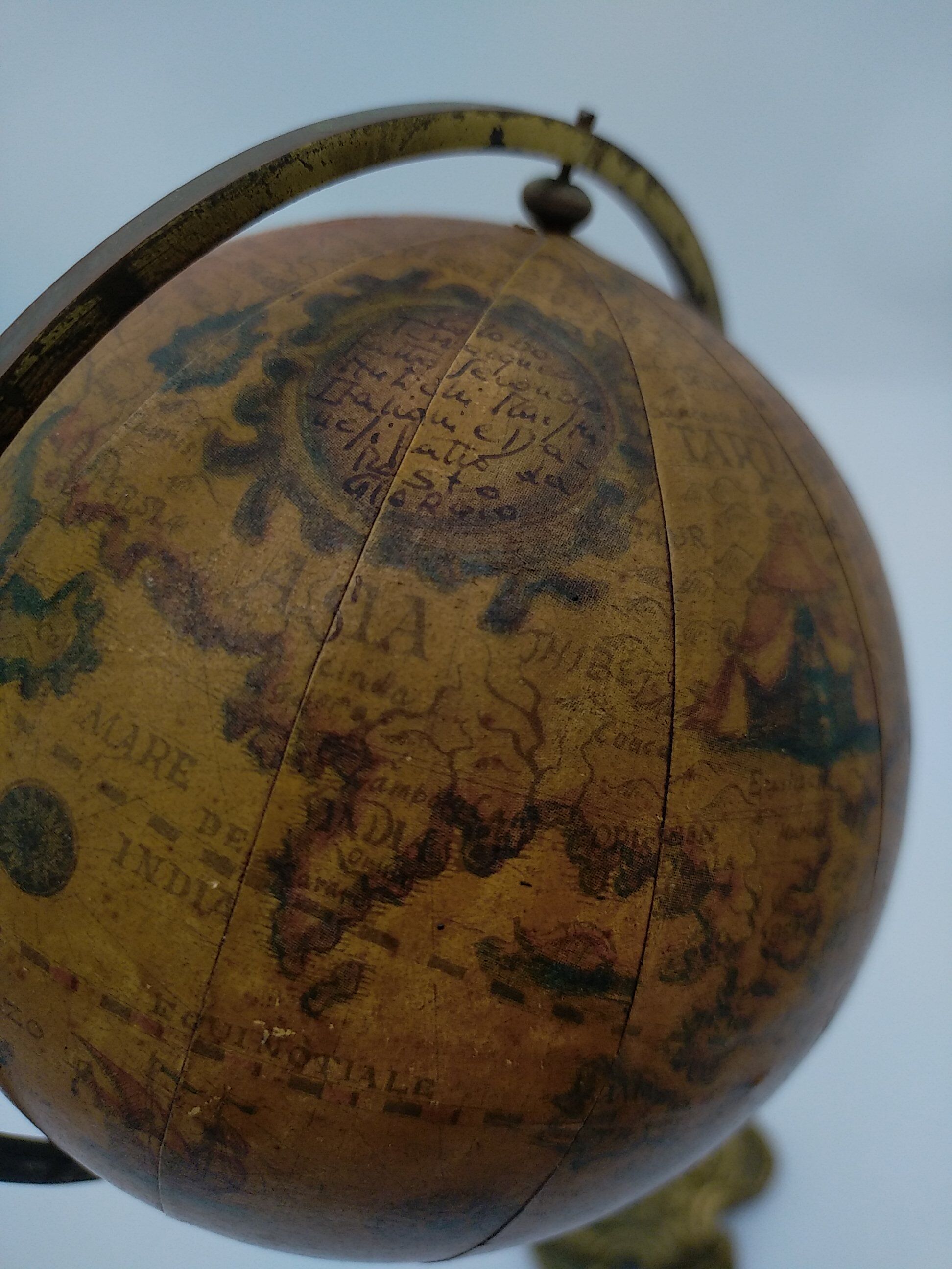 Cherub or putti carrying a globe