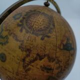 Cherub or putti carrying a globe