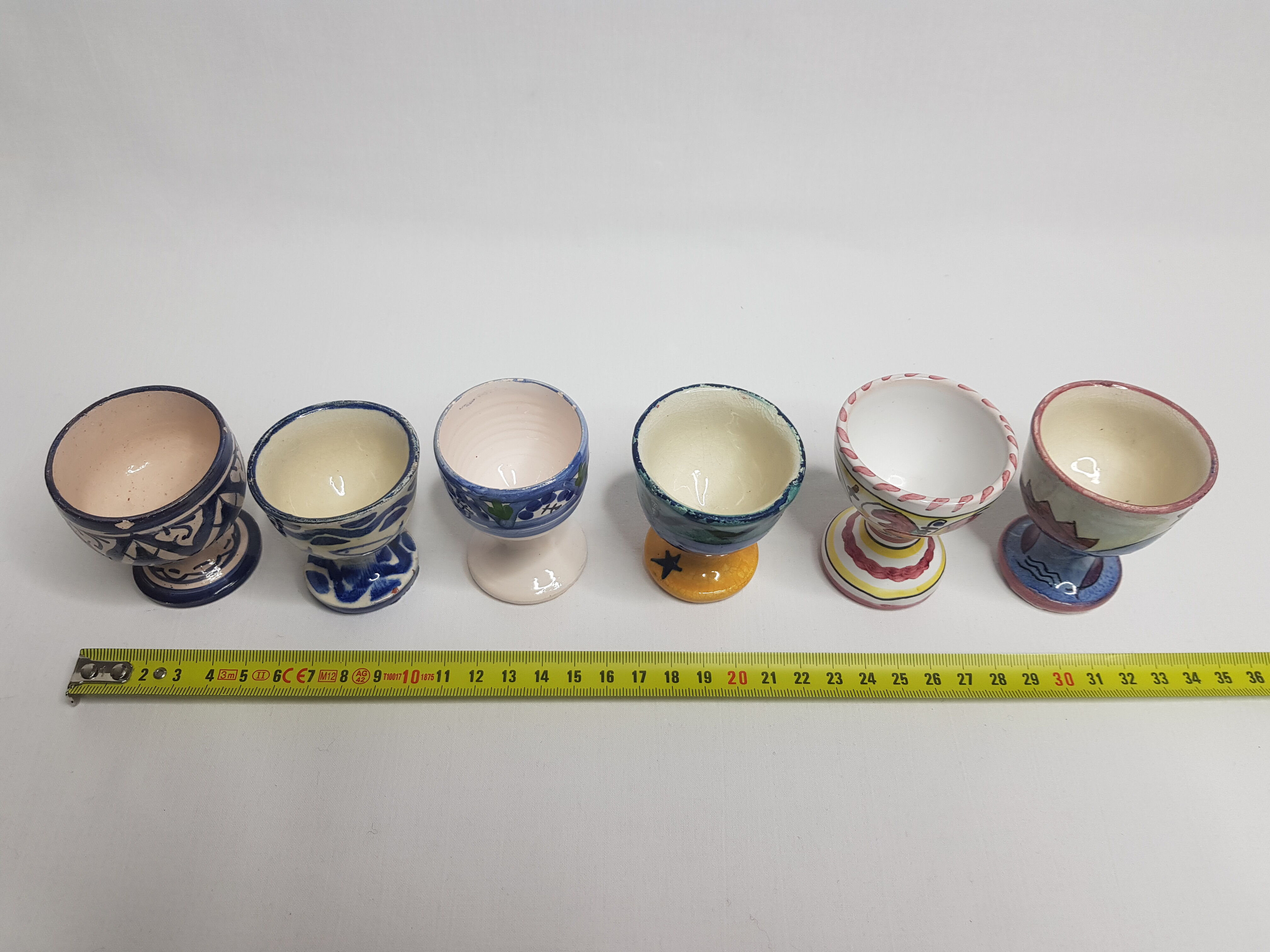 Lot of six enamelled ceramic cockroaches with Mediterranean themed decorations