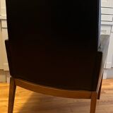 Modernist armchair in wood and black synthetic leather, circa 1960