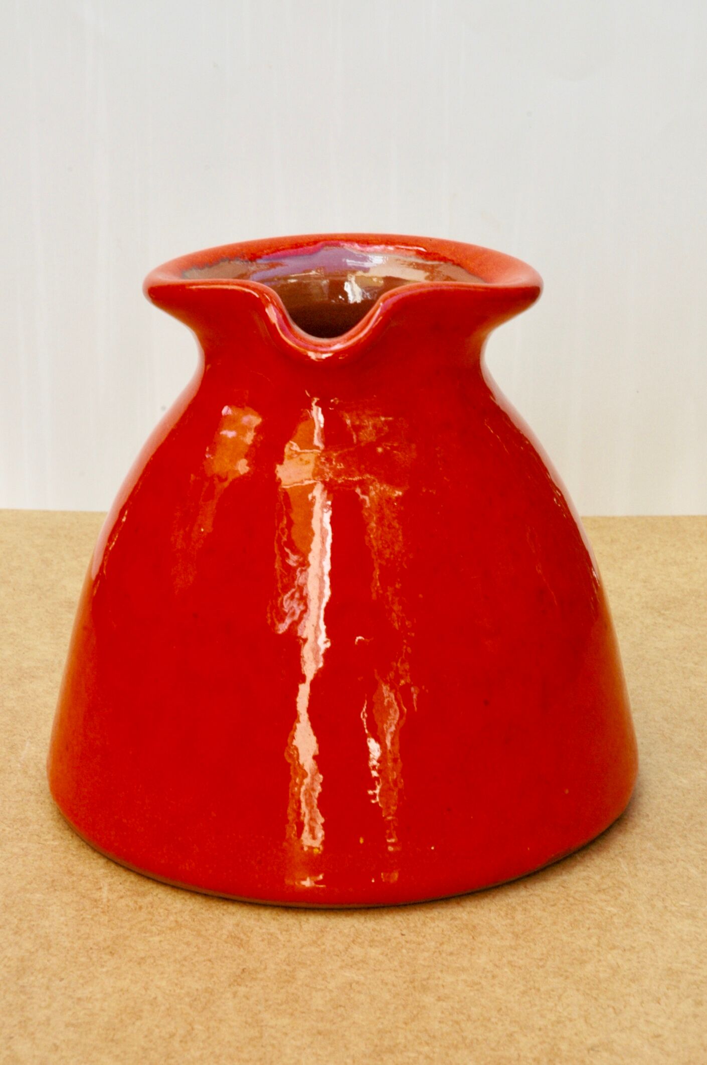 Orange earthen glazed pitcher