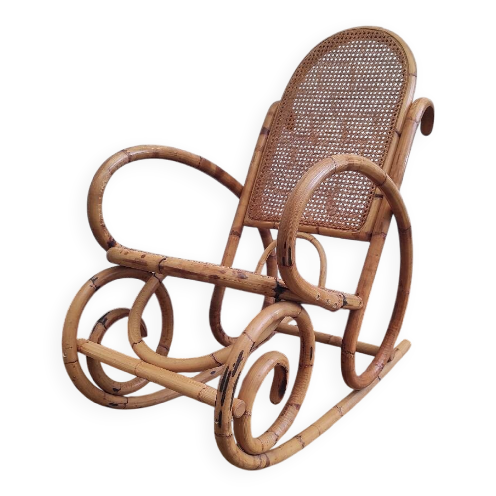 Vintage rocking chair in rattan and cane.