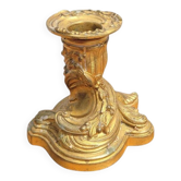Golden metal candlestick in rococo style