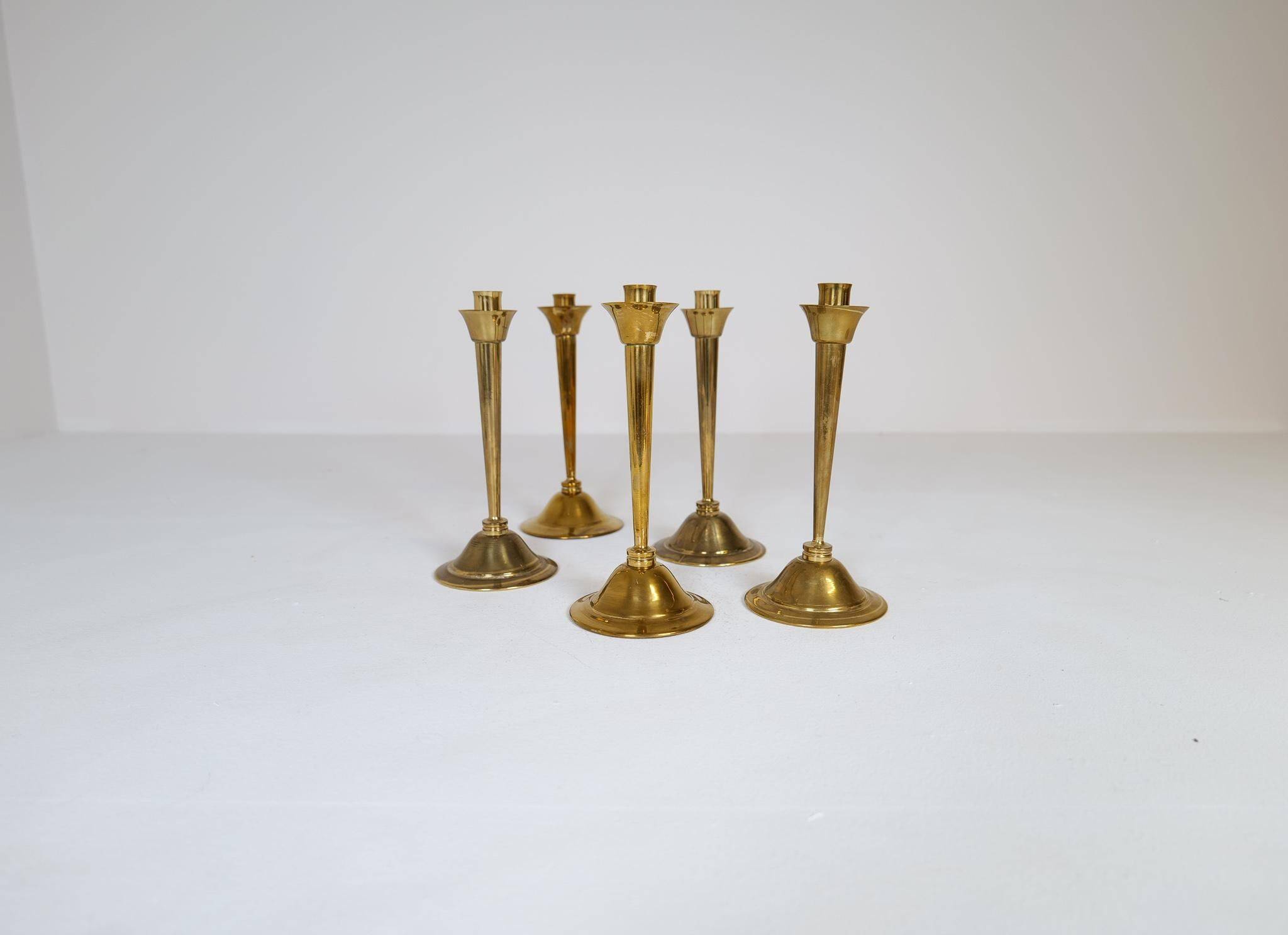Mid-century set of 5 brass candlesticks by Lars Holmström, Arvika, Sweden.