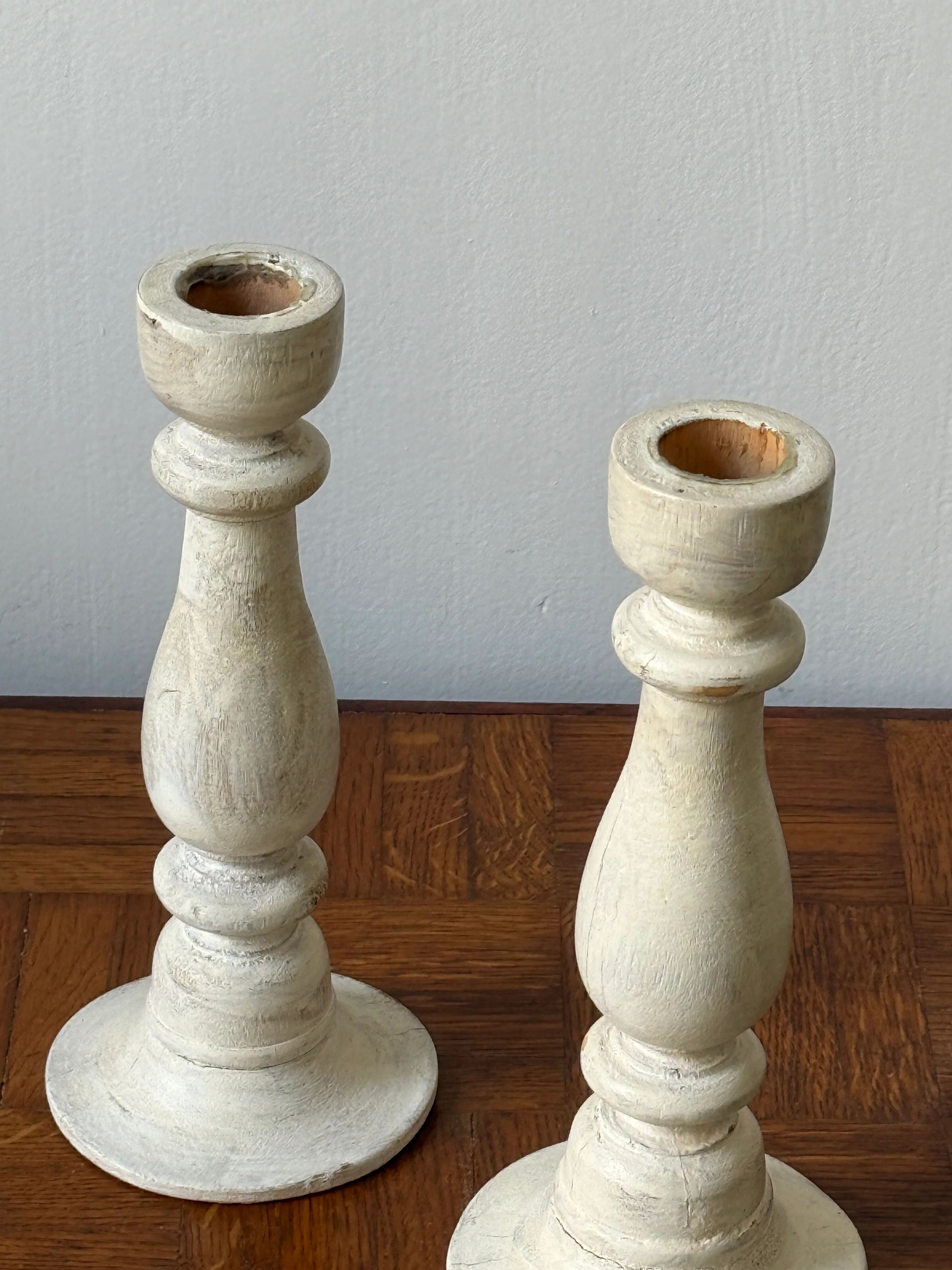 Pair of white wooden candlesticks
