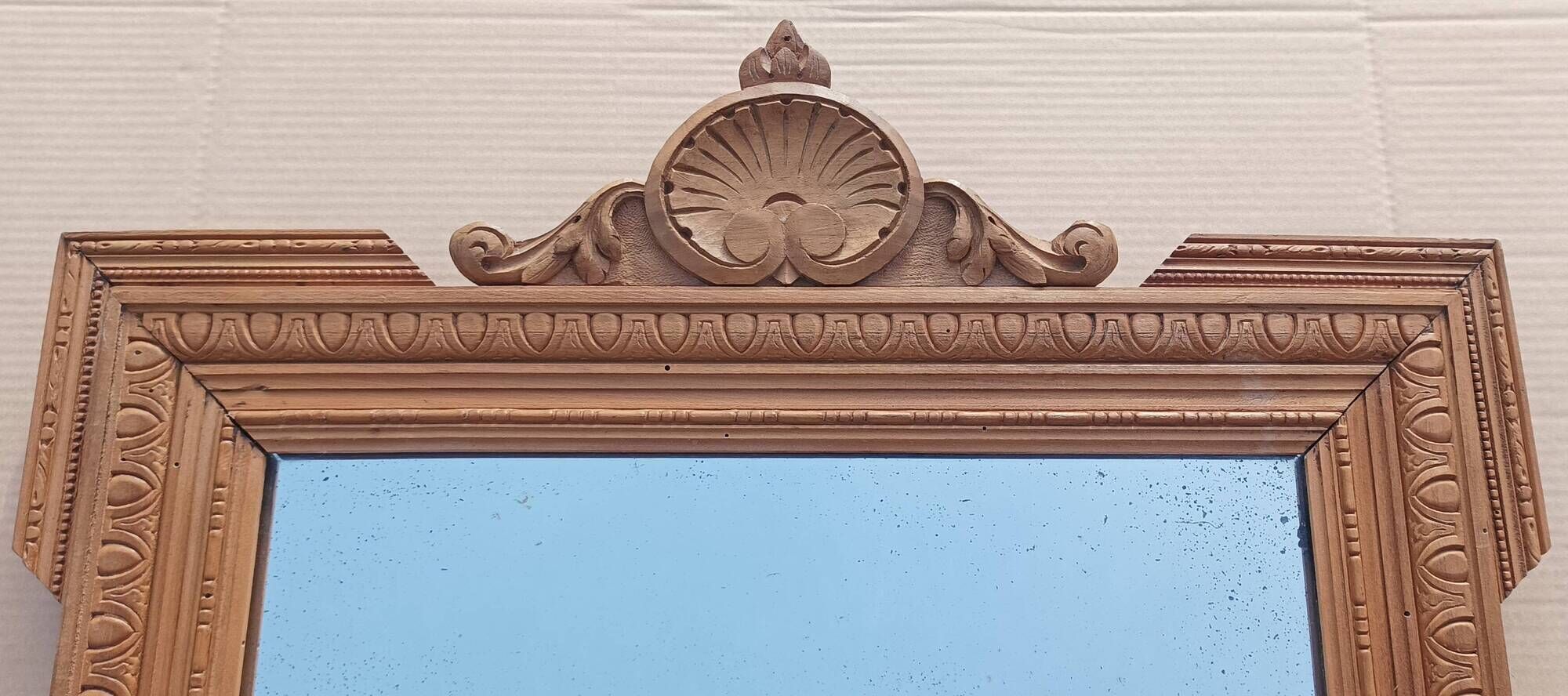 Louis XVI mirror in carved wood, 19th century.