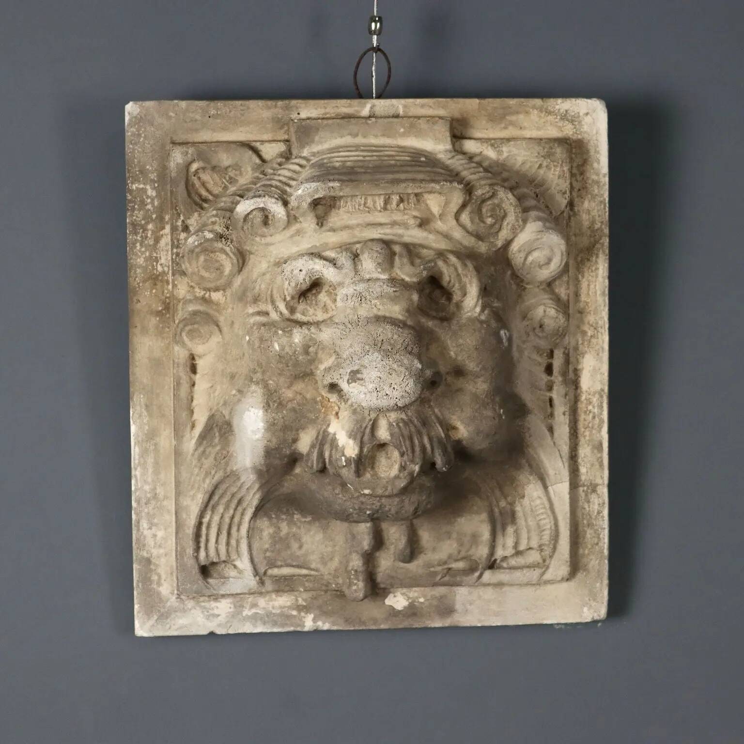 Old plaster tile with a fierce mask decoration, Italy, 19th century.