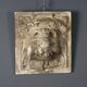 Old plaster tile with a fierce mask decoration, Italy, 19th century.