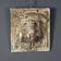 Old plaster tile with a fierce mask decoration, Italy, 19th century.