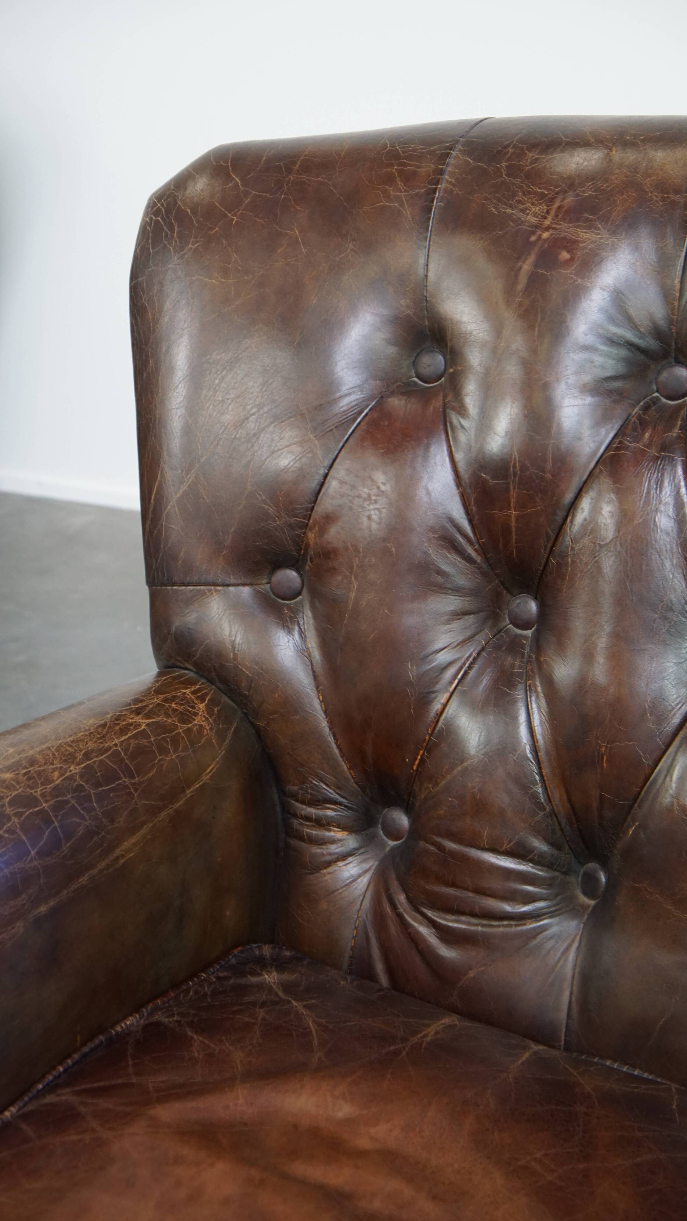 Cognac colored brown grained cowhide chesterfield armchair