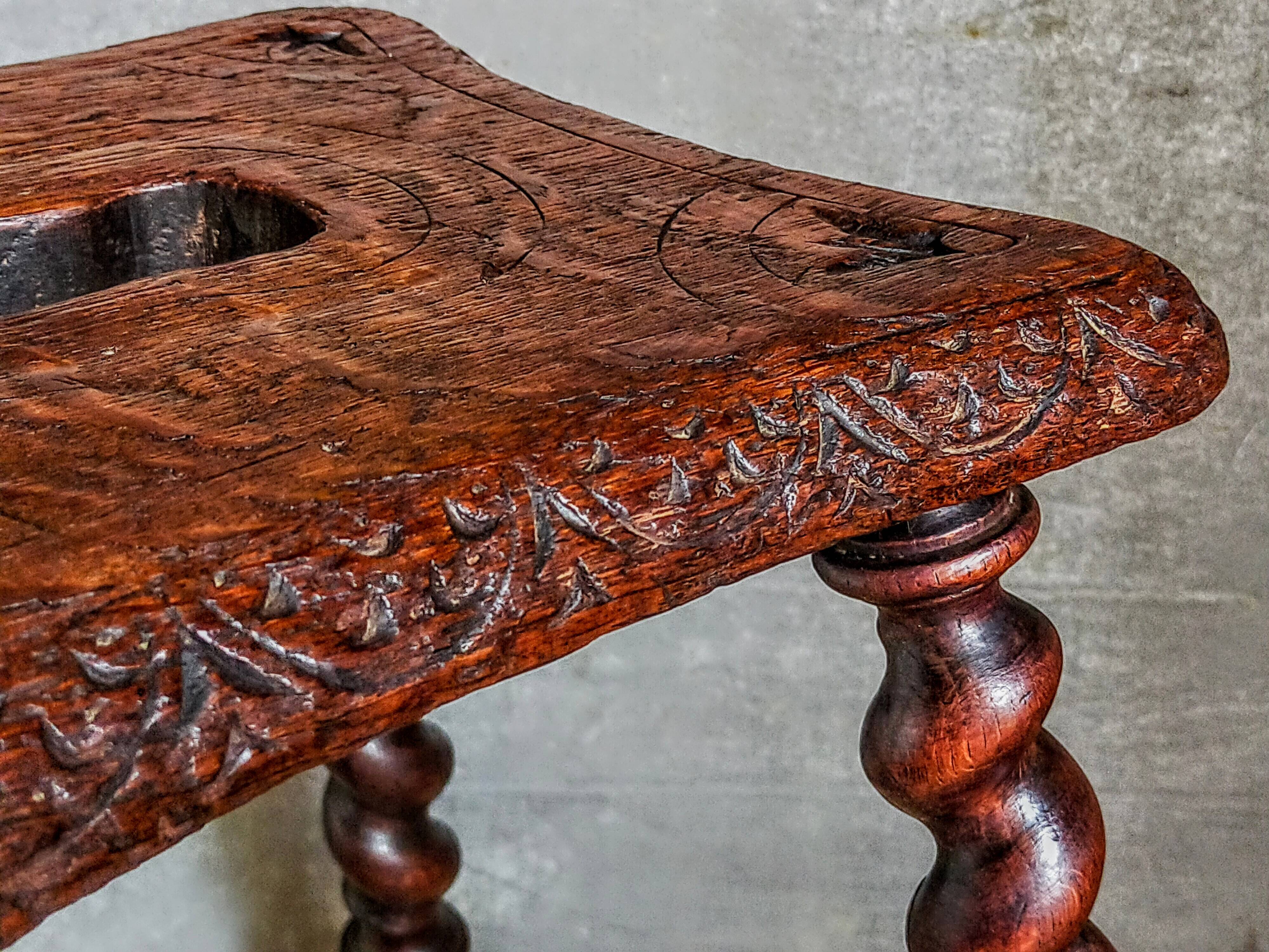 Antique stool in turned and carved solid wood
