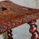 Antique stool in turned and carved solid wood