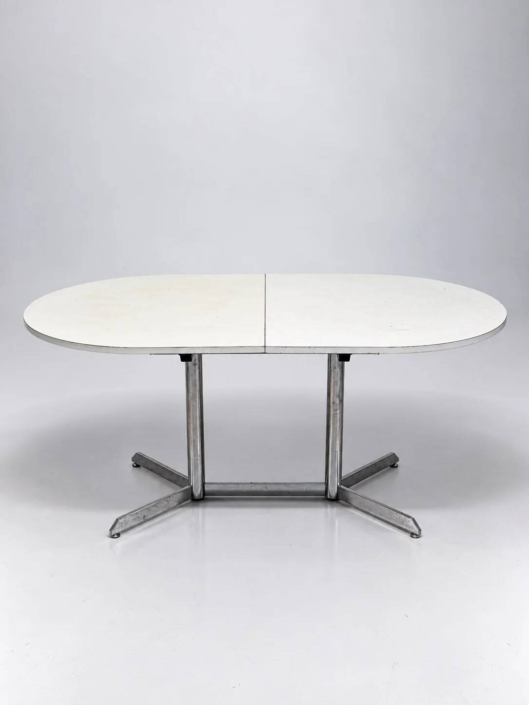 Vintage oval extendable dining table, white laminate and chrome, 1970s.